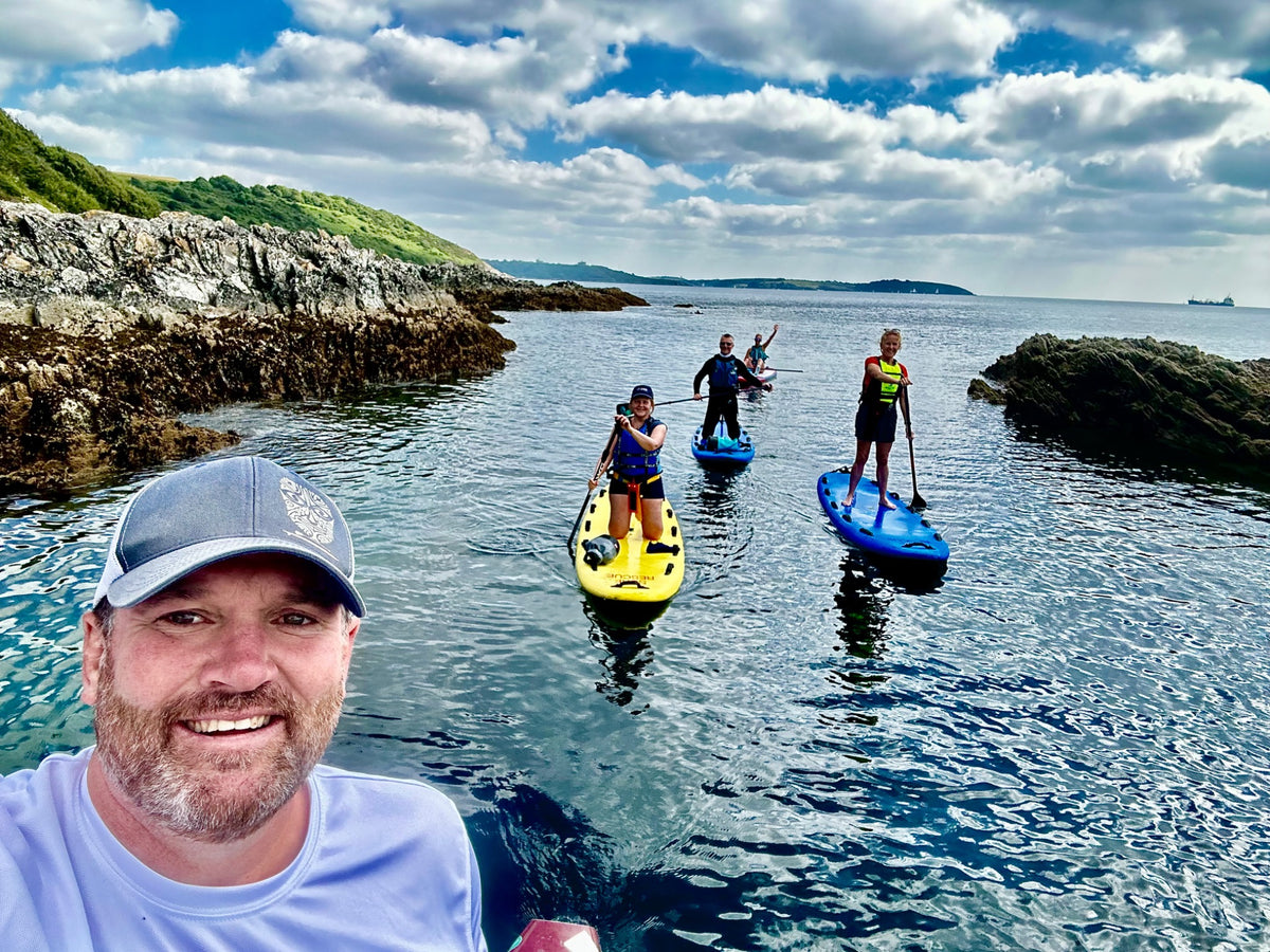 Brendon Prince leading a small group on a coastal paddle